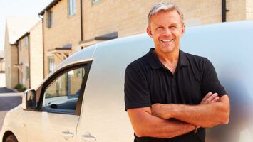 Man standing outside of vehicle.